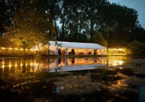 Wedding Marquee with festoon lighting by a lake